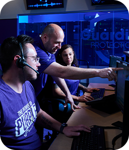 Three Protection Specialists working at Guardian's professional monitoring center.