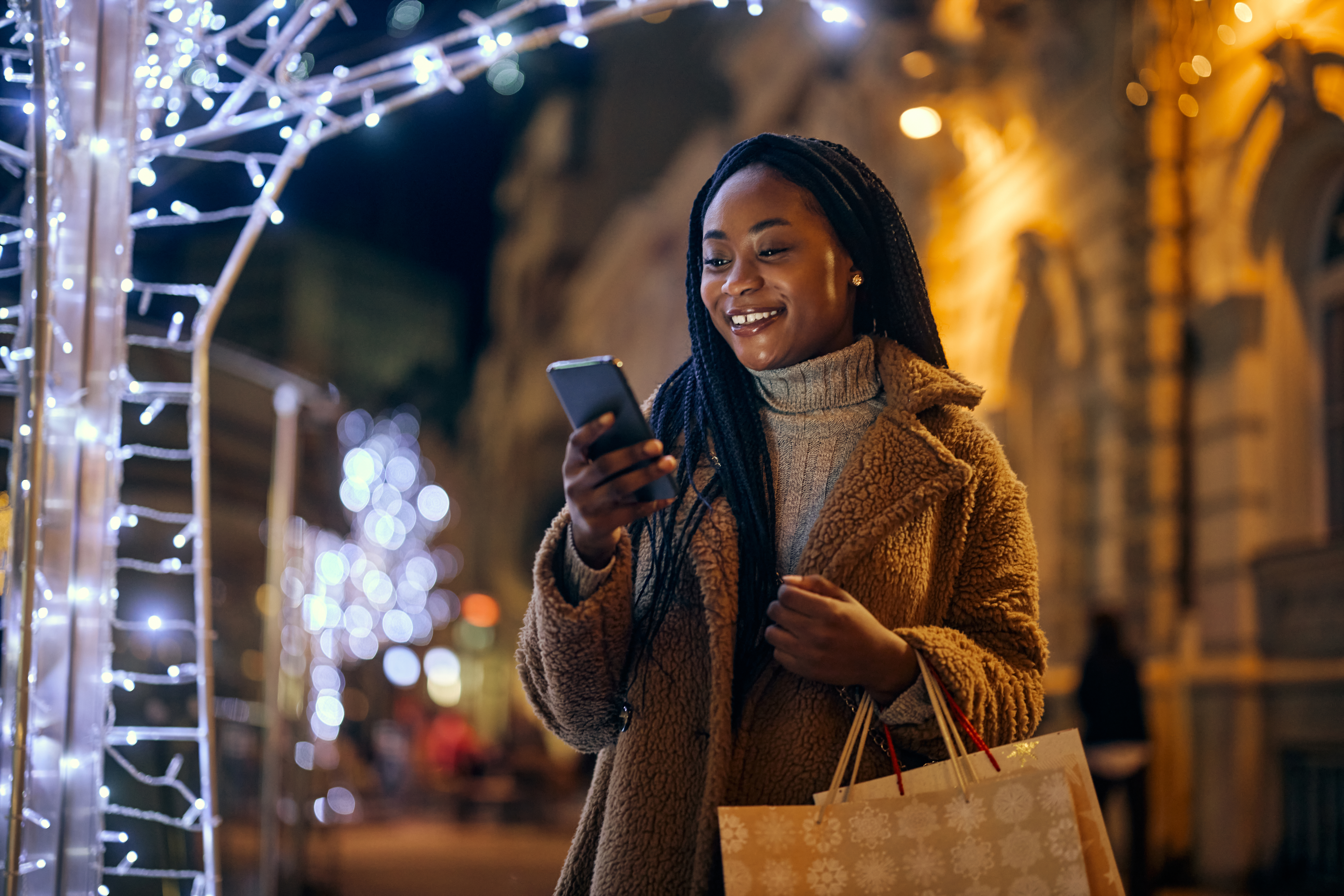 Woman shopping for the holidays looking at her Guardian Protection app