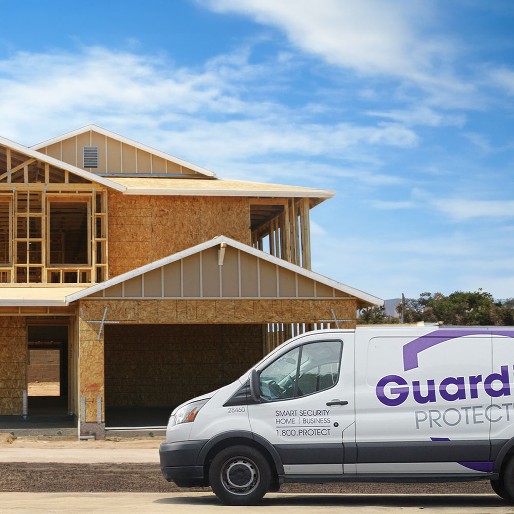 Guardian Protection van parked in front of a new home being built