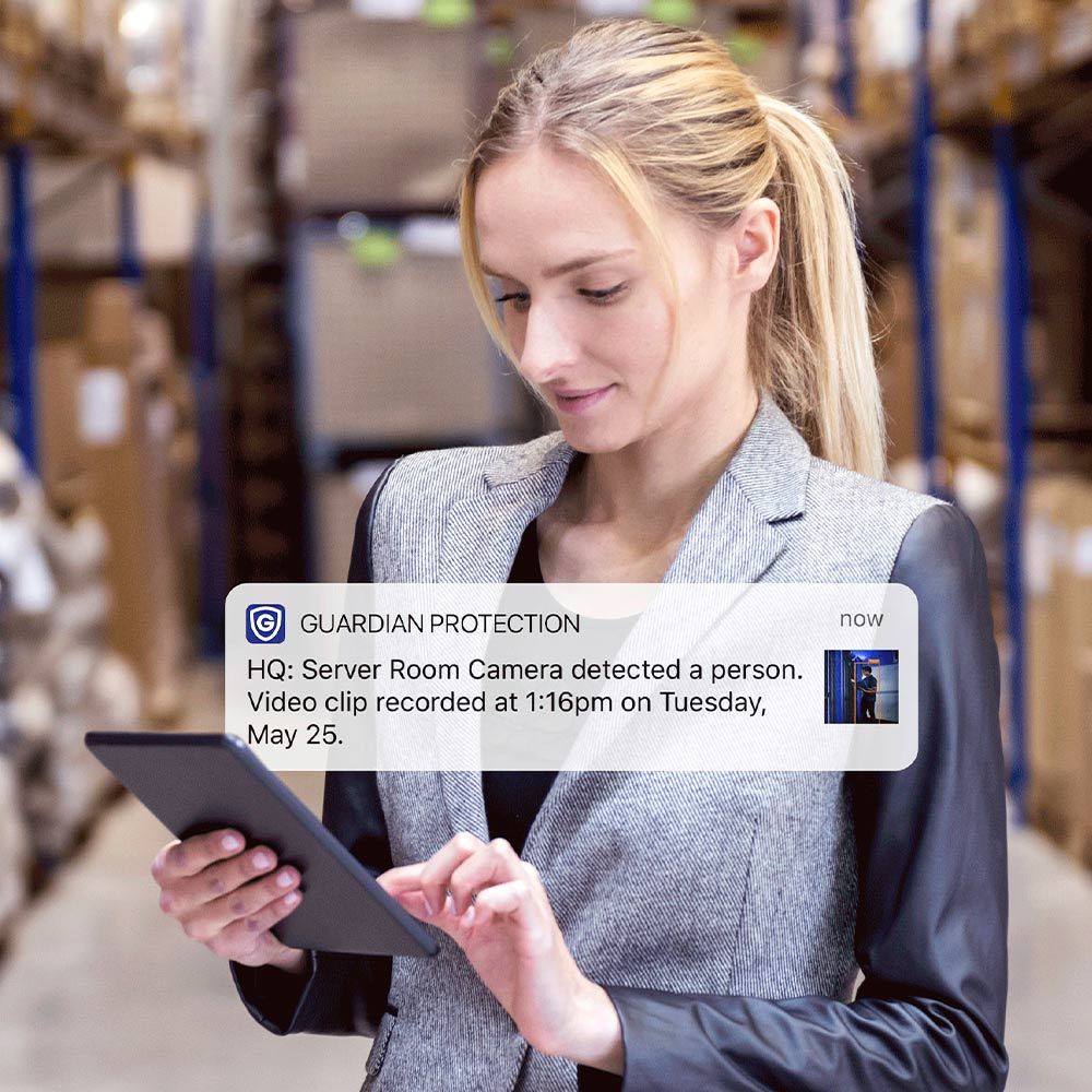 Woman getting a notification about her Guardian Protection business security camera feed