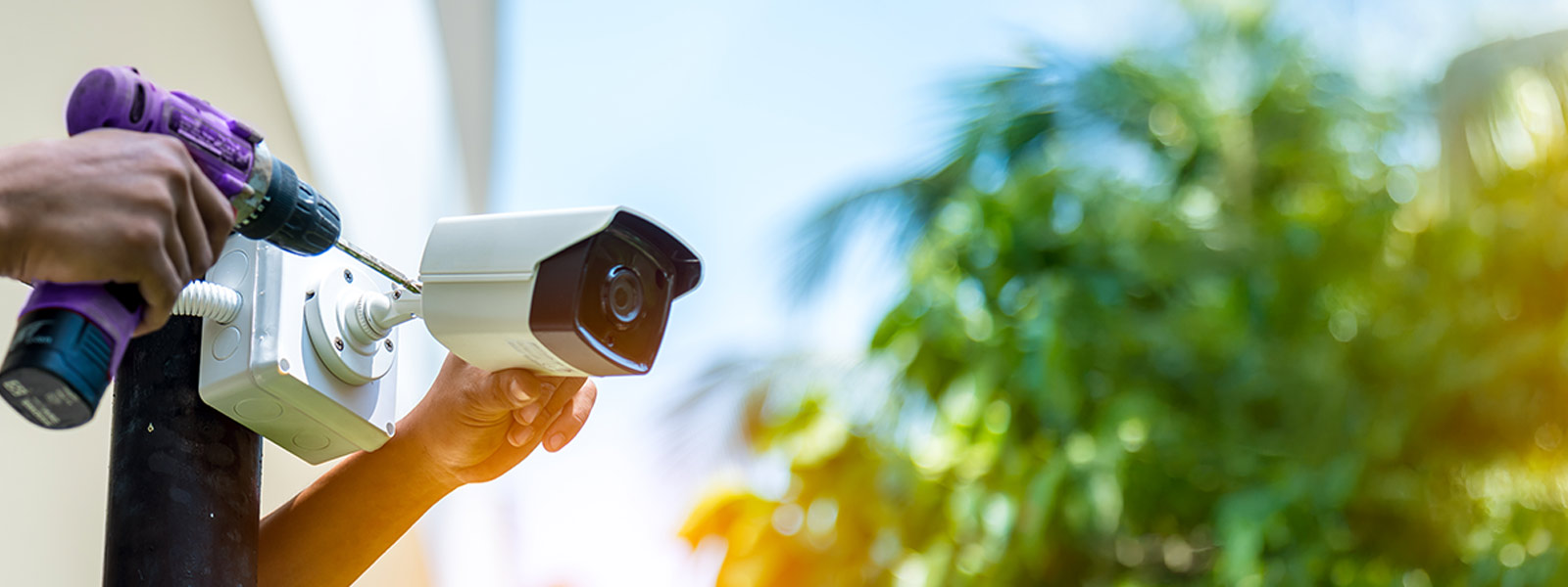 Technician installing a business security camera