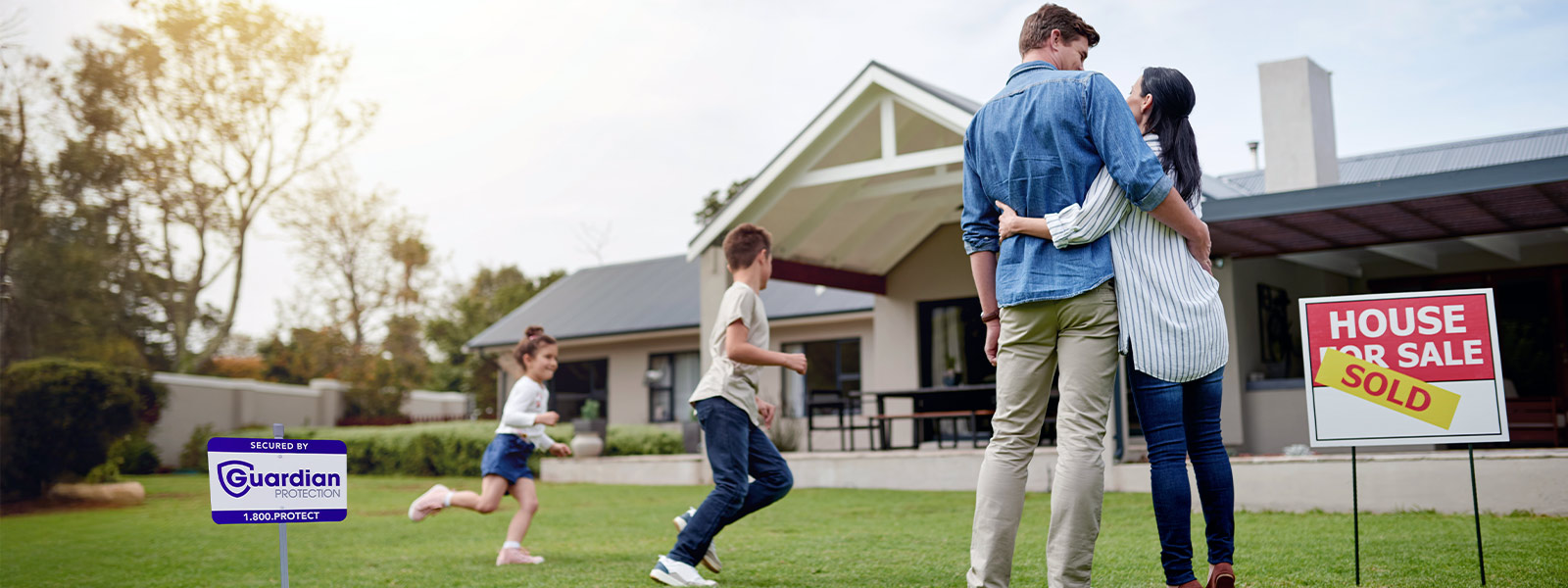 Family moving into a house protected by Guardian Protection's home security devices