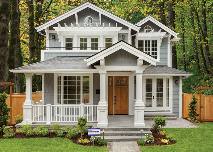 Large white house with Guardian Protection yard sign in front yard