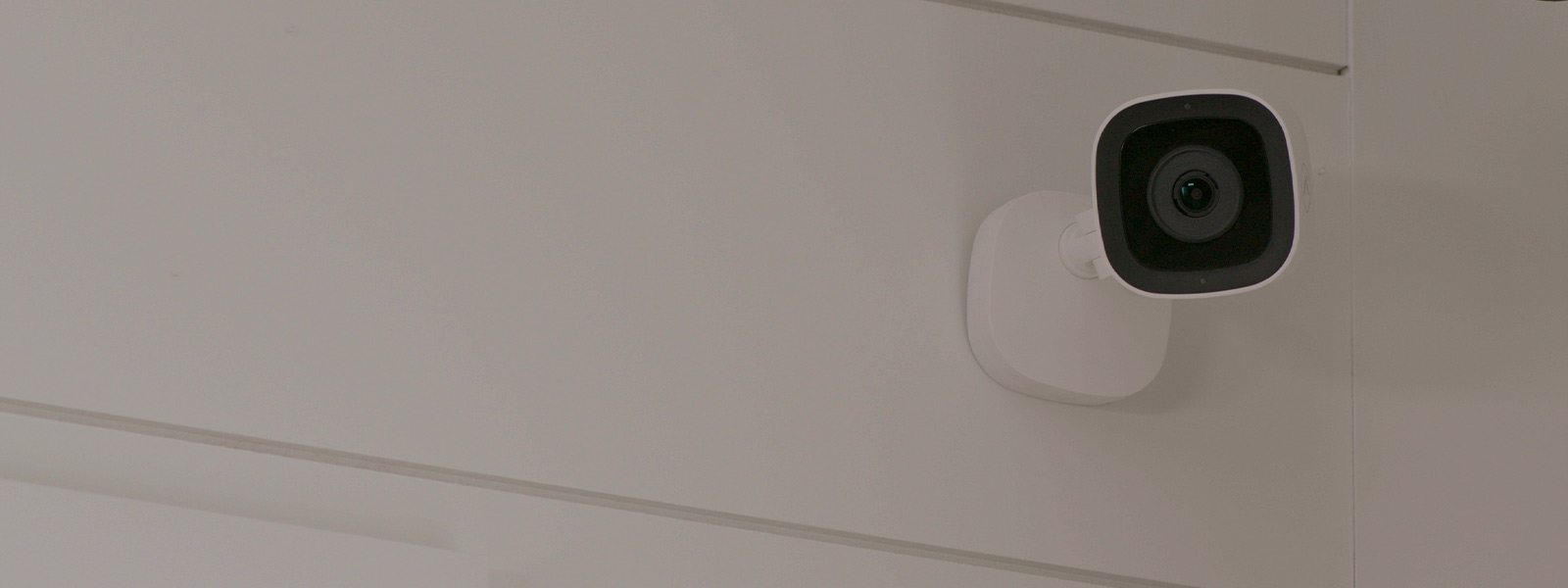 Indoor home security camera mounted on a wall