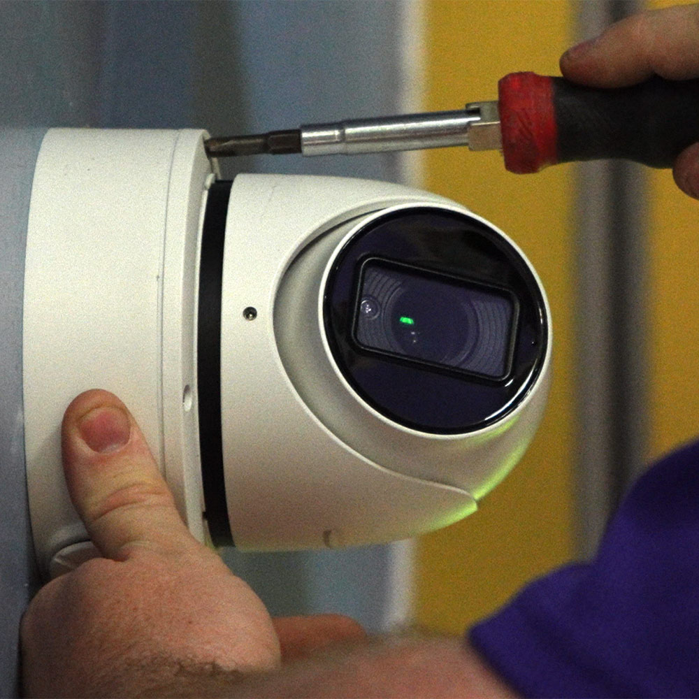 Technician installing a Guardian Protection business security camera