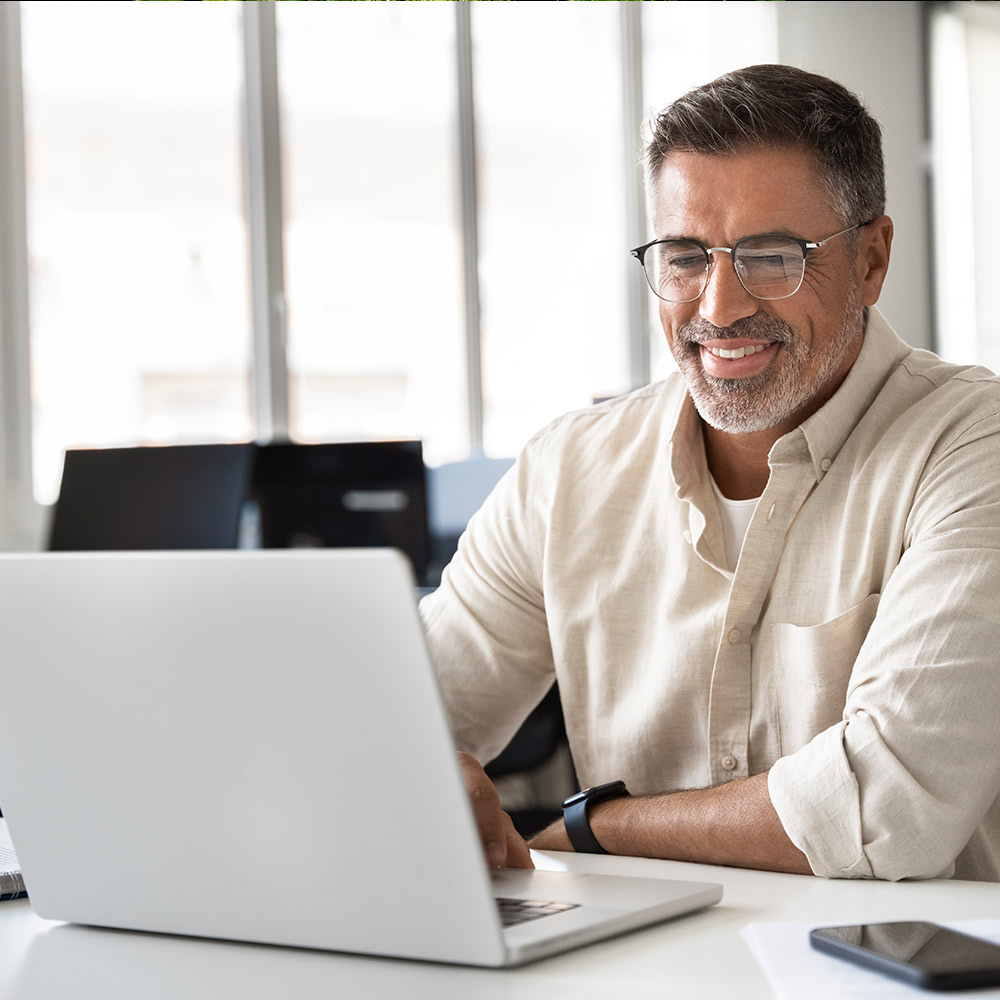 Man smiling at laptop