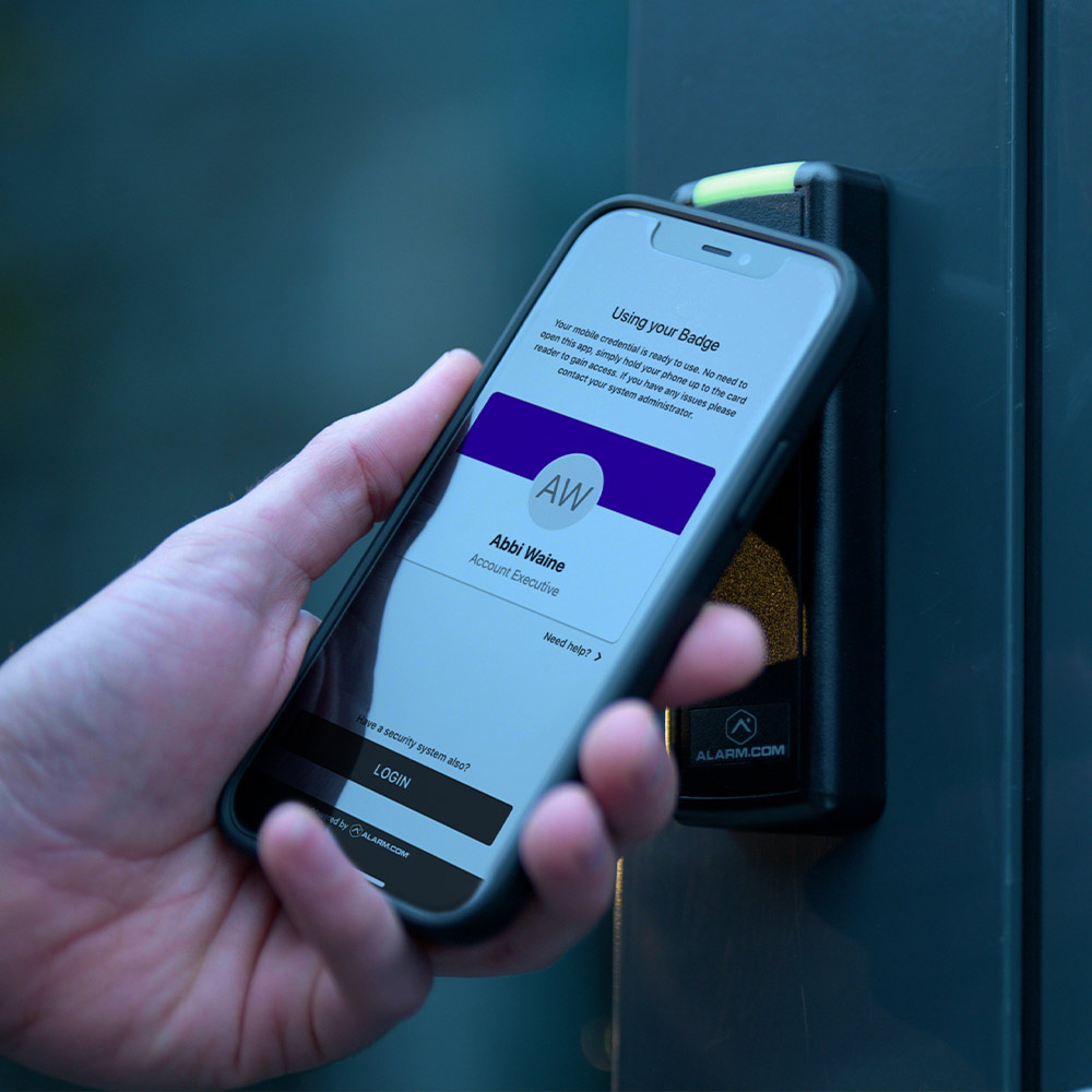 Hand holding up Guardian Protection app for door access control