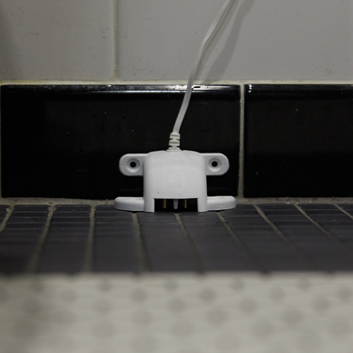 Guardian Protection water sensor mounted on tile wall