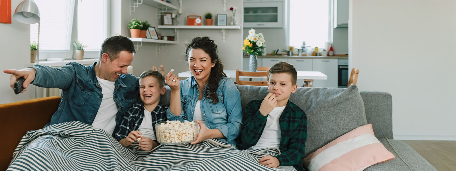 Family on couch watching movie